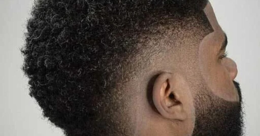 Low fade haircut on black hair with neat blend