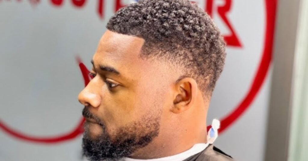 barber shaping hairline using clippers